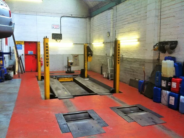 The MOT bay at RD Motors, red floor and yellow lifts
